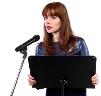 girl in shiny dress speaking on a microphone in a podium on white background