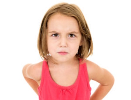 Little girl is angry, mad and looking at the camera