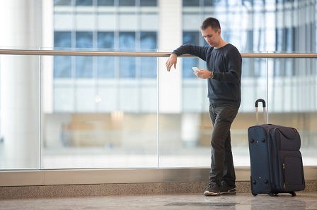 Young traveler using smartphone in airport