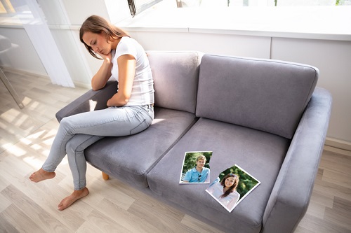 Lonely Woman Sitting On Sofa